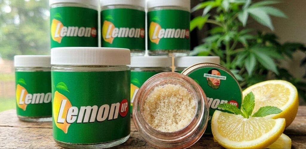 Mr. Kushington 415 branded Lemon Up solventless hash rosin in an open jar with green labels, fresh lemon slices, and a 
